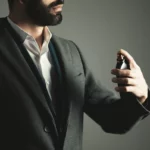 business-man-hand-holding-bottle-perfume_218381-2501