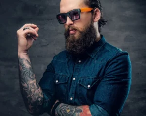 thoughtful-bearded-male-sunglasses-with-tattoos-his-arms-1